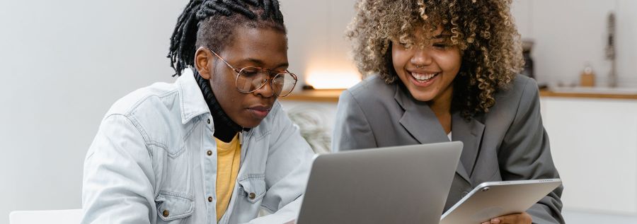two people looking at a laptop screen